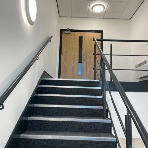 Office stairs leading to wooden door